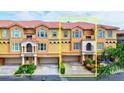 Three-story townhome with attached garage and Spanish-style architecture at 1513 Wharfside Dr # 1513, Tarpon Springs, FL 34689