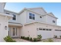 Charming two-story townhouse with a two-car garage, landscaped yard, and covered entryway at 31907 Anchor Point Dr, Wesley Chapel, FL 33545