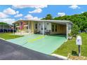 Charming single-story home with a covered parking and well-maintained lawn at 7048 El Meyers St, Zephyrhills, FL 33541