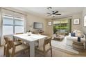 Bright dining room with seating for six and access to living room at 6919 Surrey Hill Pl, Apollo Beach, FL 33572