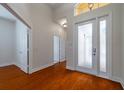 Bright and spacious entryway with hardwood floors and access to other rooms at 4943 Sandy Brook Cir, Wimauma, FL 33598