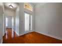 Bright and spacious entryway with hardwood floors and access to other rooms at 4943 Sandy Brook Cir, Wimauma, FL 33598