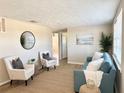 Inviting living room featuring neutral walls, cozy seating, and natural light, creating a welcoming atmosphere at 3245 Bigelow Dr Dr, Holiday, FL 34691