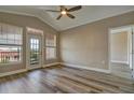 Bright bedroom with wood floors, a ceiling fan, and a door leading to a balcony at 5000 Culbreath Key Way # 4-306, Tampa, FL 33611