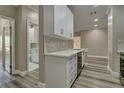 Modern kitchen featuring white cabinets, quartz countertops, stainless steel appliances, and a stylish backsplash at 5000 Culbreath Key Way # 4-306, Tampa, FL 33611