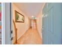 Inviting foyer features tile flooring, fresh paint and access to the stairway at 521 Pinellas Bayway S # 202, St Petersburg, FL 33715