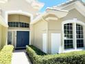 Inviting entryway with a double door and landscaping at 6515 Virginia Xing, University Park, FL 34201