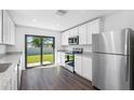 Modern kitchen with stainless steel appliances and granite countertops at 13064 Meadow Swallow Ave, Weeki Wachee, FL 34614