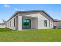 Rear exterior view of the house with a covered patio at 14499 Mount Ivy Rd, Brooksville, FL 34614
