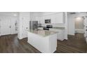 Modern kitchen with island, stainless steel appliances, and flooring at 14499 Mount Ivy Rd, Brooksville, FL 34614
