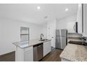 Modern kitchen featuring stainless steel appliances and granite countertops at 14499 Mount Ivy Rd, Brooksville, FL 34614