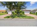 Two-car garage home with nicely landscaped yard at 15626 Aurora Lake Cir, Wimauma, FL 33598