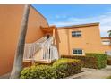 Exterior view of condo building showcasing entrance and landscaping at 7400 Sunshine Skyway S Ln # 106, St Petersburg, FL 33711