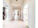 Bright and spacious hallway with tile flooring, offering views into other rooms at 4949 Sandy Brook Cir, Wimauma, FL 33598