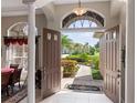 Elegant entryway with double doors opening to a view of the backyard and golf course at 13217 Thoroughbred Dr, Dade City, FL 33525