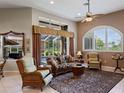 Relaxing living room featuring wicker furniture and access to the pool area at 13217 Thoroughbred Dr, Dade City, FL 33525