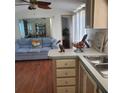 The kitchen flows to the living room with a cozy couch and unique decor at 21027 Lazy Days Cir, Lutz, FL 33558