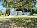 Cute cottage style home with a detached garage and large shade tree at 1478 Alternate Keene Rd, Largo, FL 33771