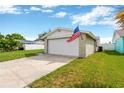 Single car garage with a large driveway at 3234 Jackson Dr, Holiday, FL 34691
