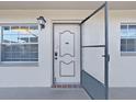 Condo unit featuring a white front door with sidelight windows at 1370 Heather Ridge Blvd # 107, Dunedin, FL 34698