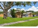 Ranch style home with stone and wood accents at 1921 Blue Heron Way, Palm Harbor, FL 34683