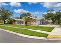 Ranch style home with stone and wood accents at 1921 Blue Heron Way, Palm Harbor, FL 34683