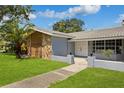 Ranch style home with stone and wood accents at 1921 Blue Heron Way, Palm Harbor, FL 34683