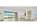 Bright and spacious living area with tile floors and sliding glass doors leading to a lake view at 32252 Wetland Bird Vw, San Antonio, FL 33576