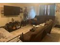 Living room with comfortable seating and a large-screen TV at 9463 Arbol Ct, Largo, FL 33773