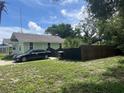 Light green house with a driveway and a wooden fence at 1161 Kingsley St, Clearwater, FL 33756