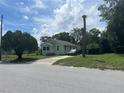Light green house on a quiet street with palm trees at 1161 Kingsley St, Clearwater, FL 33756
