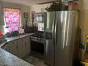 Modern kitchen features stainless steel appliances and granite countertops at 1161 Kingsley St, Clearwater, FL 33756
