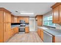 Bright kitchen featuring wood cabinets and stainless steel appliances at 6430 Willow Wood Ln, Tampa, FL 33634