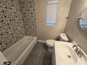 Updated bathroom with patterned tile and a new vanity at 3208 E Powhatan Ave, Tampa, FL 33610