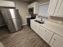 Modern kitchen features stainless steel appliances and white cabinetry at 3208 E Powhatan Ave, Tampa, FL 33610