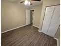 Bright bedroom with wood-look flooring and ample closet space at 3208 E Powhatan Ave, Tampa, FL 33610