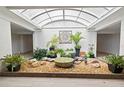 Indoor atrium with plants and water features creates a relaxing atmosphere at 500 Treasure Island Cswy # 406, Treasure Island, FL 33706