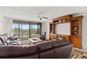 Living room with furniture, TV and sliding doors to outside balcony at 500 Treasure Island Cswy # 406, Treasure Island, FL 33706