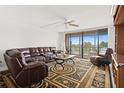 Relaxing living room featuring a large sectional sofa and access to a balcony at 500 Treasure Island Cswy # 406, Treasure Island, FL 33706
