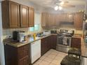 Cozy kitchen with wood cabinets, stainless steel appliances, and a breakfast bar at 120 S San Remo Ave, Clearwater, FL 33755