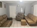 Simple living room with brown leather couches and a recliner at 120 S San Remo Ave, Clearwater, FL 33755