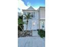 Light blue townhome with walkway and landscaping at 11335 Grandville Dr, Temple Terrace, FL 33617