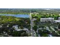An aerial view showcases the neighborhood with lush greenery and nearby lake access at 911 8Th Sw Ave, Largo, FL 33770