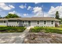 Newly built home with gray siding, stone accents and a landscaped yard at 911 8Th Sw Ave, Largo, FL 33770