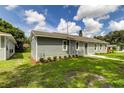 Newly constructed home with gray siding, landscaping, and a spacious yard at 911 8Th Sw Ave, Largo, FL 33770