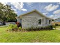 Newly built home with gray siding, stone accents, and well-manicured landscaping at 911 8Th Sw Ave, Largo, FL 33770