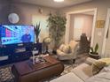 Bright living room featuring a cozy seating area and large TV at 1874 Douglas Ave, Clearwater, FL 33755