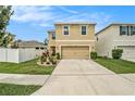 Two-story house with driveway, landscaping and a white fence at 3508 Diamond Leaf Ct, Valrico, FL 33594