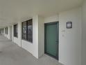 Hallway with access to condo unit, offering a welcoming entry point to the living space at 7100 Sunset Way # 405, St Pete Beach, FL 33706