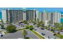 Aerial view of beachfront condo building with ample parking and convenient access to the beach at 7100 Sunset Way # 405, St Pete Beach, FL 33706